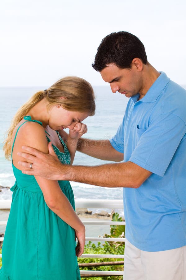 Young man comforting a crying woman. Young man comforting a crying woman