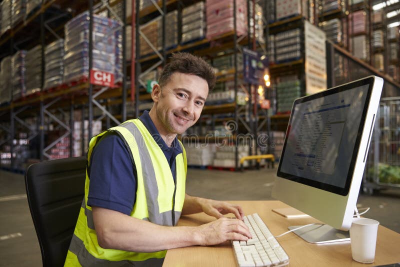 Man at Computer in onsite Warehouse Office Looks To Camera Stock Image Image of office, desk