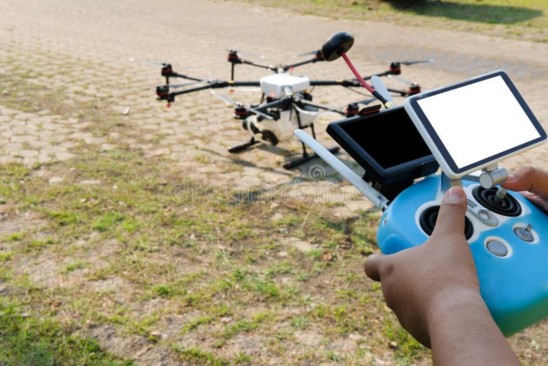 Man Controlling Agriculture Drone. Remote Controller Stock Photo