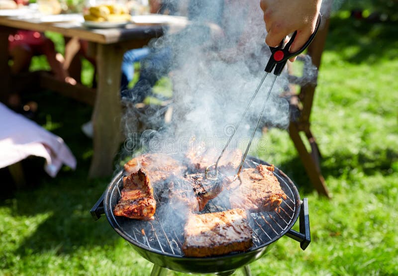Man Cooking Meat on Barbecue Grill at Summer Party Stock Photo - Image ...