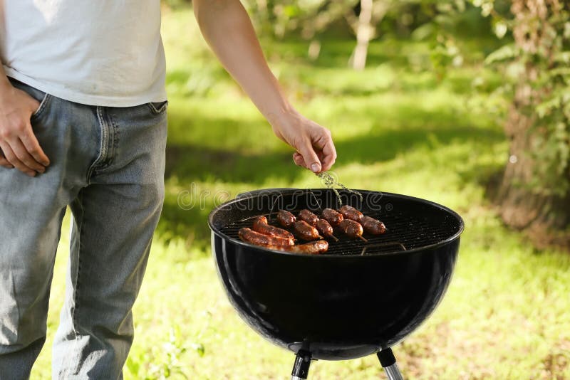 Man Cooking Sausages on Barbecue Grill Outdoors Stock Photo Image of