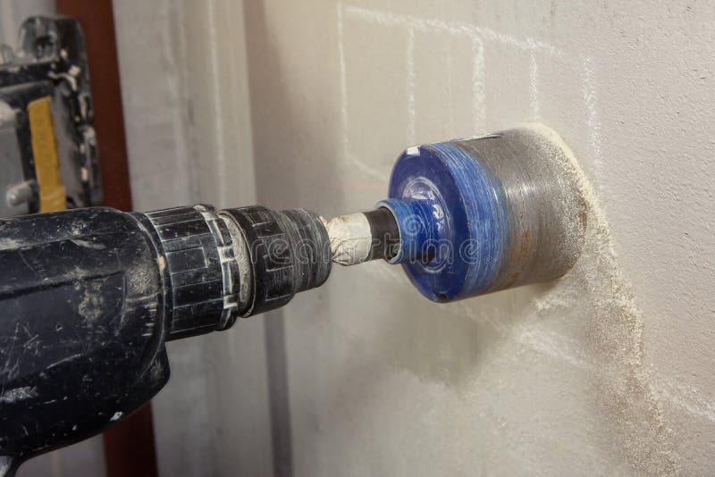 Man with Cordless Hand Drill Drilling a Hole in Concrete Stock Image