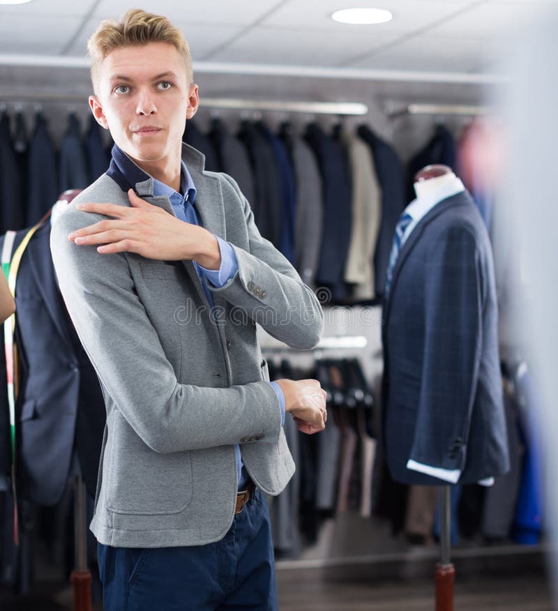 Man Costumer Trying Jacket in Mirror Indoors Stock Image - Image of ...