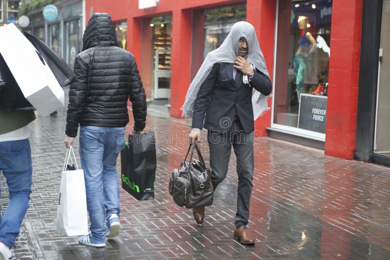 The Man Covered His Head by Jacket in Heavy Rain. Editorial Stock Image ...