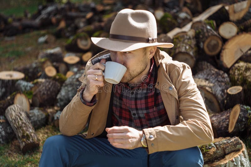 Man Cowboy Hat Drinking Morning Coffee in Countryside Stock Image