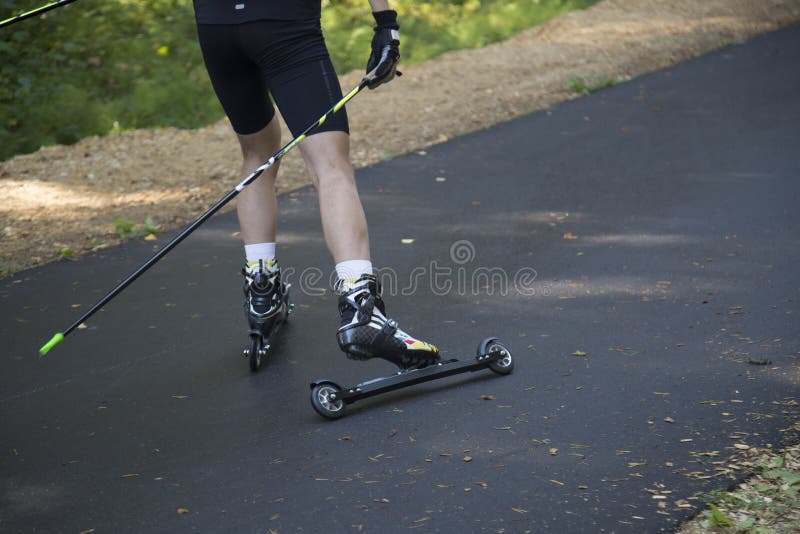 Man CrossCountry Skiing with Roller Skis in the Park Stock Image