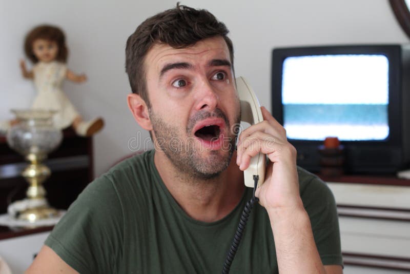 Man crying at home during phone conversation royalty free stock photography Man crying at home during phone conversation royalty free stock photography
