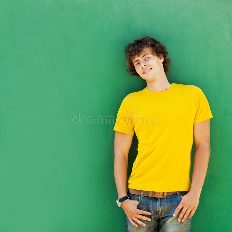Man with curly hair in a yellow T-shirt stock photo Man with curly hair in a yellow T-shirt stock photo