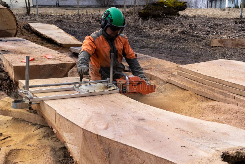 A Man Cuts Boards Using a Mobile Chainsaw Mill Stock Image Image of