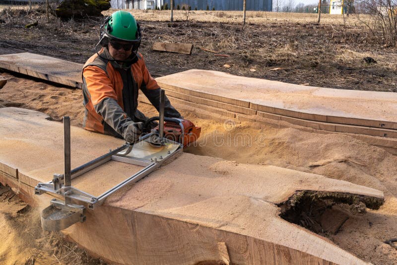 A Man Cuts Boards Using a Mobile Chainsaw Mill Stock Photo Image of