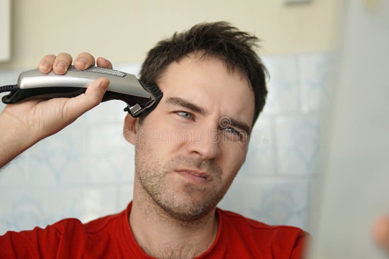 A Man Cuts His Hair on His Head with an Electric Razor. Suffering from Cutting  Hair. Clean Yourself Up on Your Own Stock Image - Image of face, haircut:  181503855