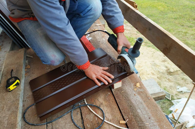 A Man Cuts a Metal Sheet with an Angle Grinder Stock Image Image of