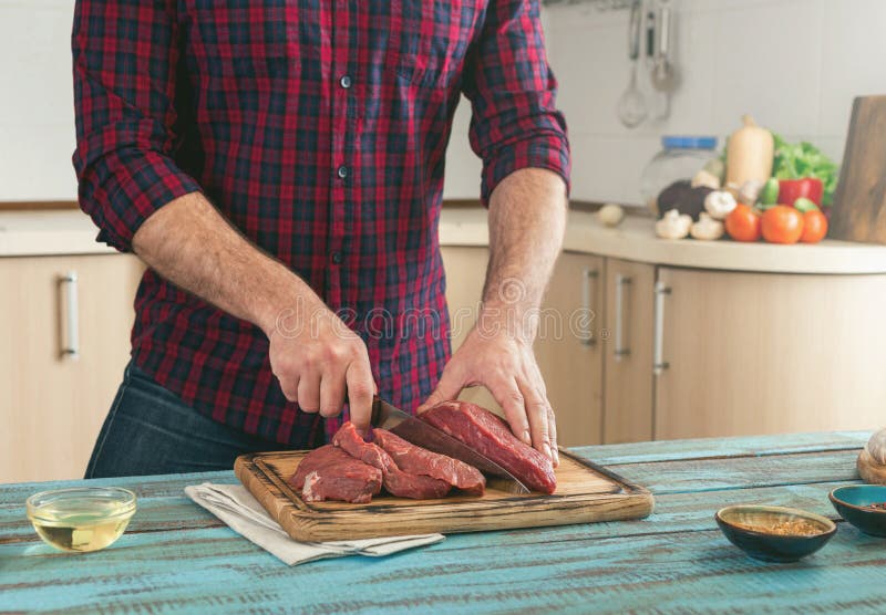 Man Cuts Piece of Meat on Wooden Cutting Board Stock Photo Image of