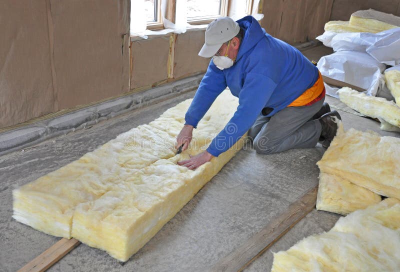 Man cutting fiberglass insulation stock photos Man cutting fiberglass insulation stock photos