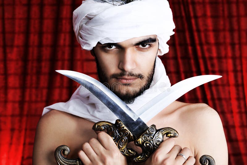 Man with daggers stock images