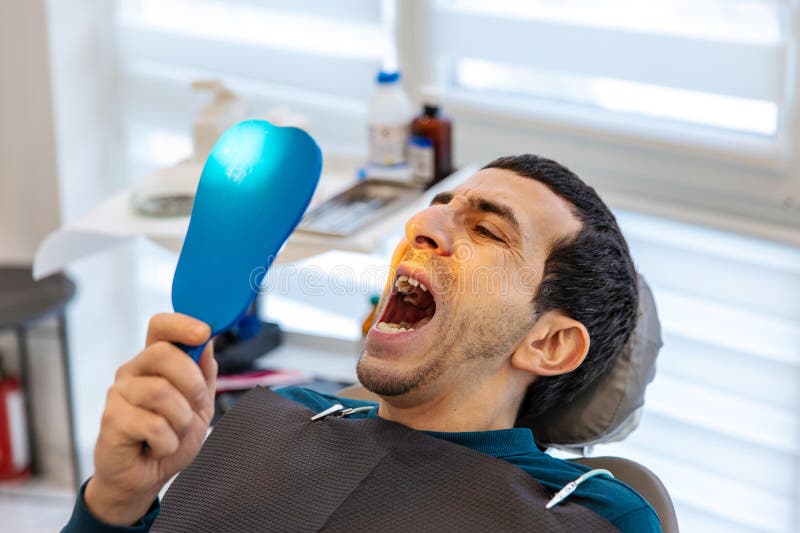 A man at a dentist appointment. Selective focus. stock photos