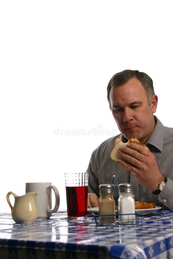 Man in diner eating sandwich