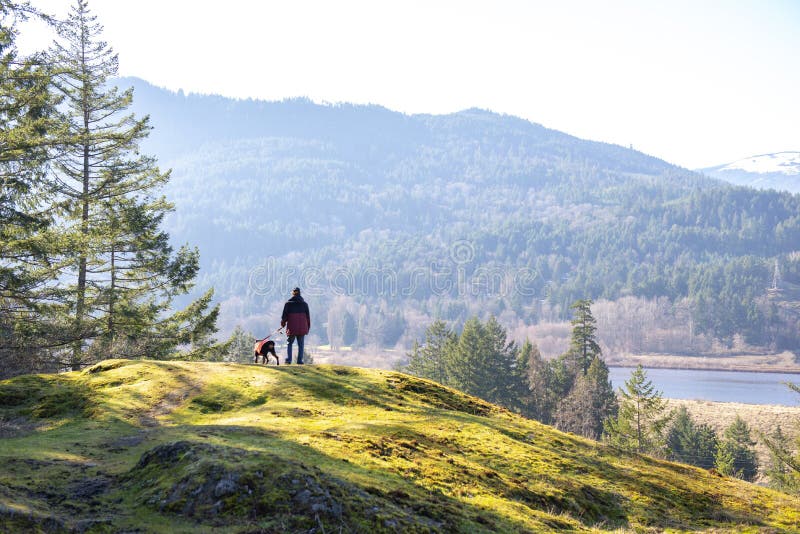 Man and dog hiking on Vancouver Island, BC, Canada