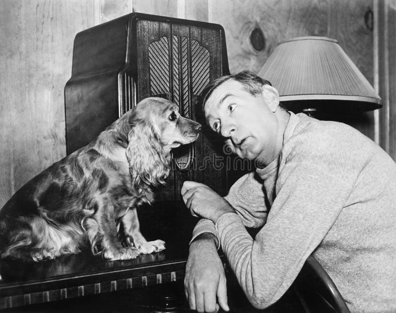 Man and dog listening to the radio