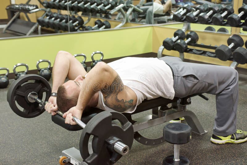 Man Doing E Z Curl Bar Skullcrusher Stock Image Image Of Hair