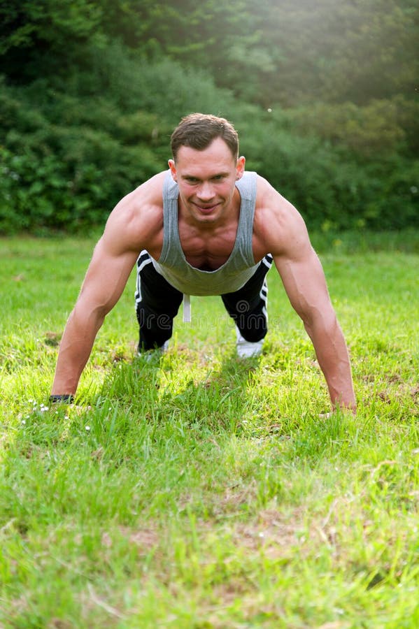 Man Doing Fitness Exercise On The Grass Stock Image Image Of Casual