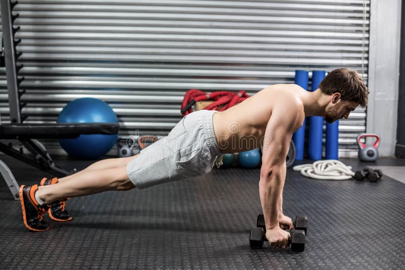 Man doing push up with dumbells