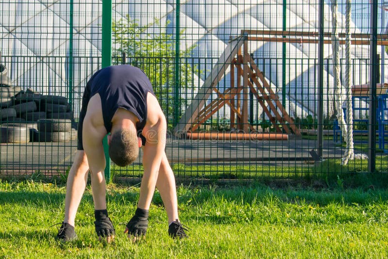 Man doing sports outdoors stretching his back royalty free stock photos Man doing sports outdoors stretching his back royalty free stock photos