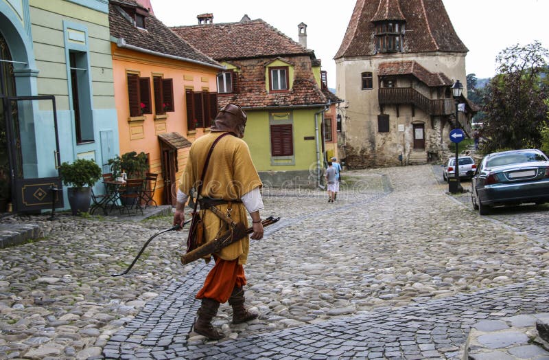 Man dressed in the costume of a medieval archer goes on one of t stock photography Man dressed in the costume of a medieval archer goes on one of t stock photography