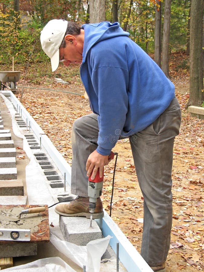 Man drilling concrete block royalty free stock image
