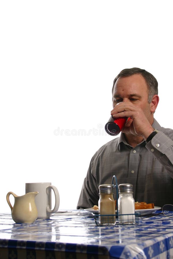 Man drinking beverage in a diner