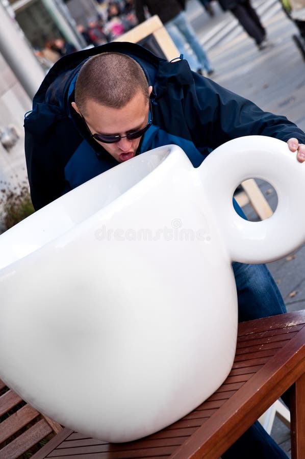 Man drinking from huge cup stock photo. Image of humour 35337660