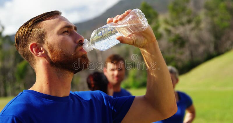 Man drinking water in boot camp 4k stock video