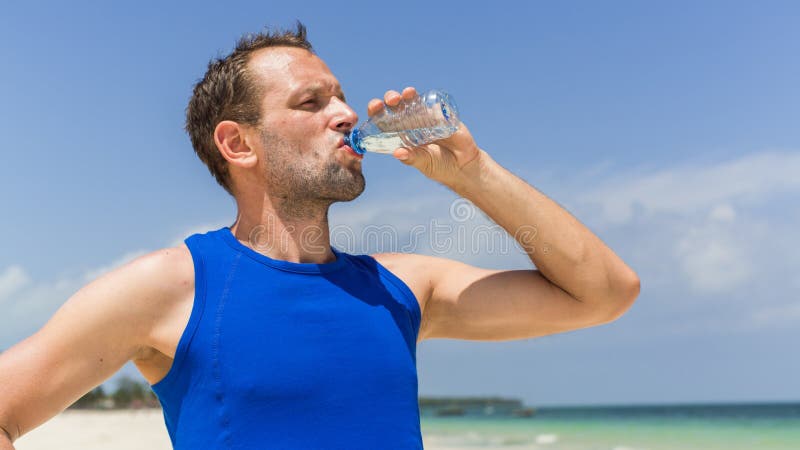 Man Drinking Water after Running at Beach. Thirsty Sport Runner Stock ...
