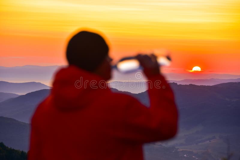Man drinking water in sunrise landscape in background. Drink, pure water concept photo stock image Man drinking water in sunrise landscape in background. Drink, pure water concept photo stock image