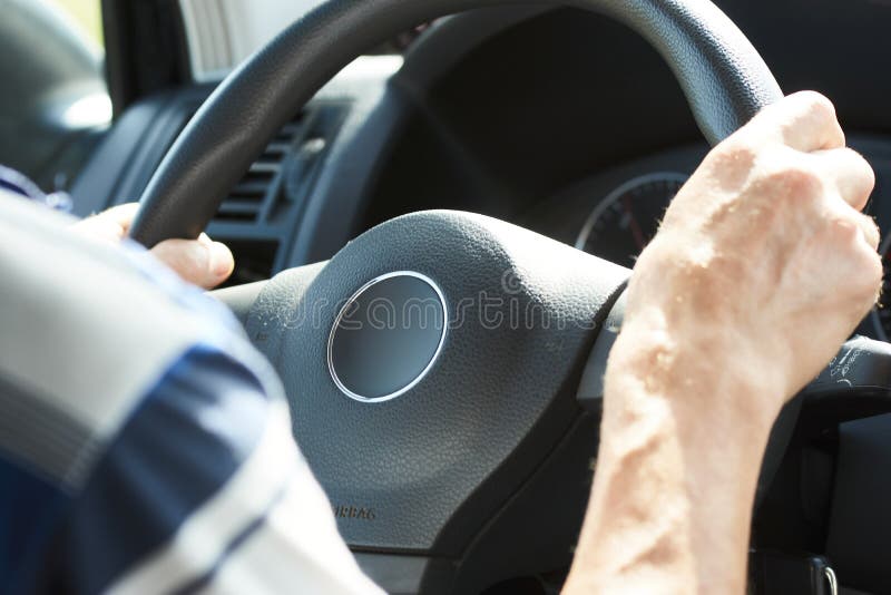 Man Driving Car, Closeup. Driver Hands Holding Steering Wheel Stock