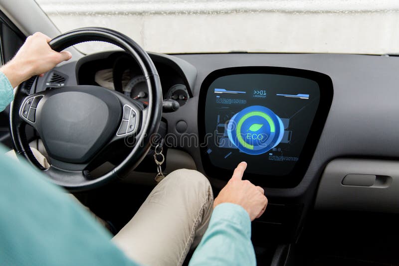 Man Driving Car With Eco Mode On Board Computer Stock