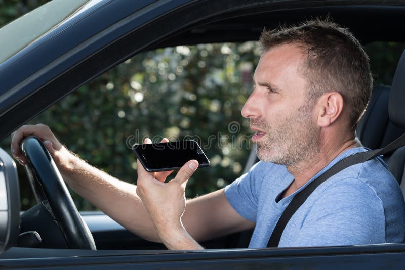 Man driving car and using mobile phone royalty free stock images Man driving car and using mobile phone royalty free stock images