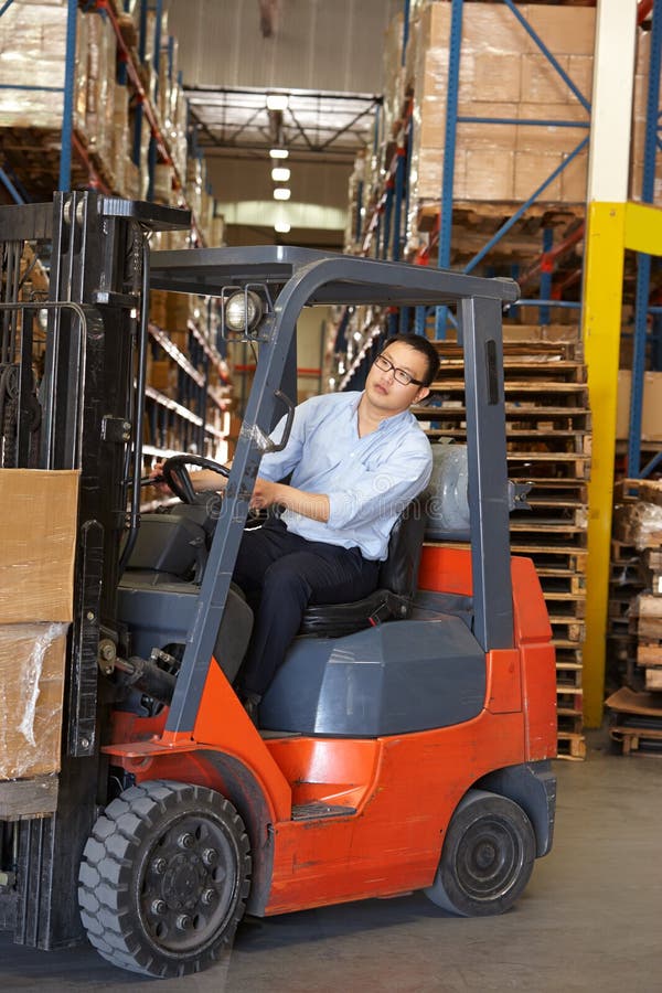 Man Driving Fork Lift Truck in Warehouse Stock Image Image of indoors