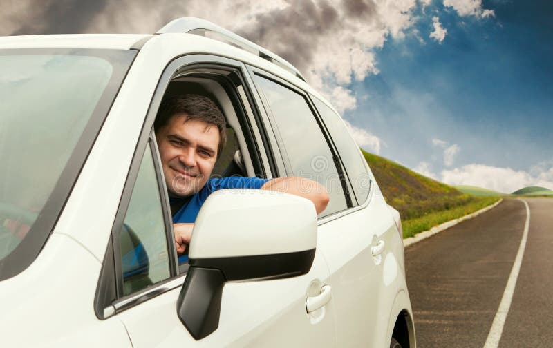 Happy owner driving his new car on the lonely road. Happy owner driving his new car on the lonely road