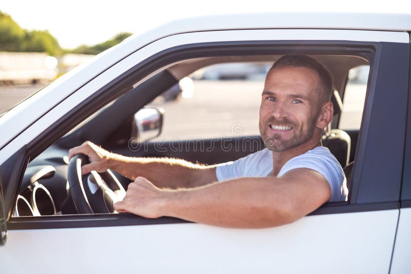A man driving a white car. stock image. Image of environment 158794727