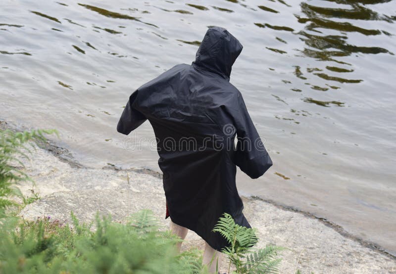 Man in Dry Changing Robe after Wild Swim Outdoors Stock Photo Image
