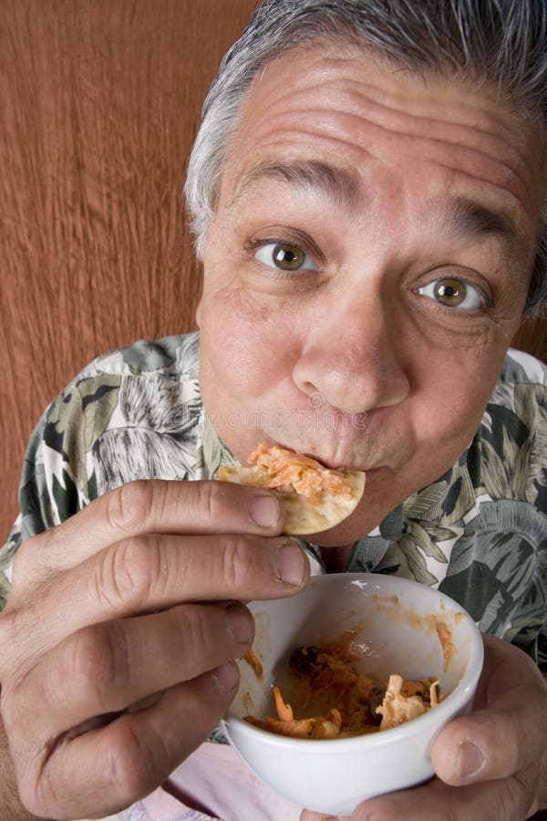 Man Eating Chips and Dip stock photo. Image of latino 5731398