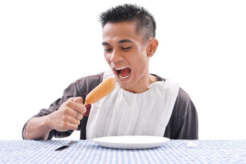 Man Eating A Corn Dog