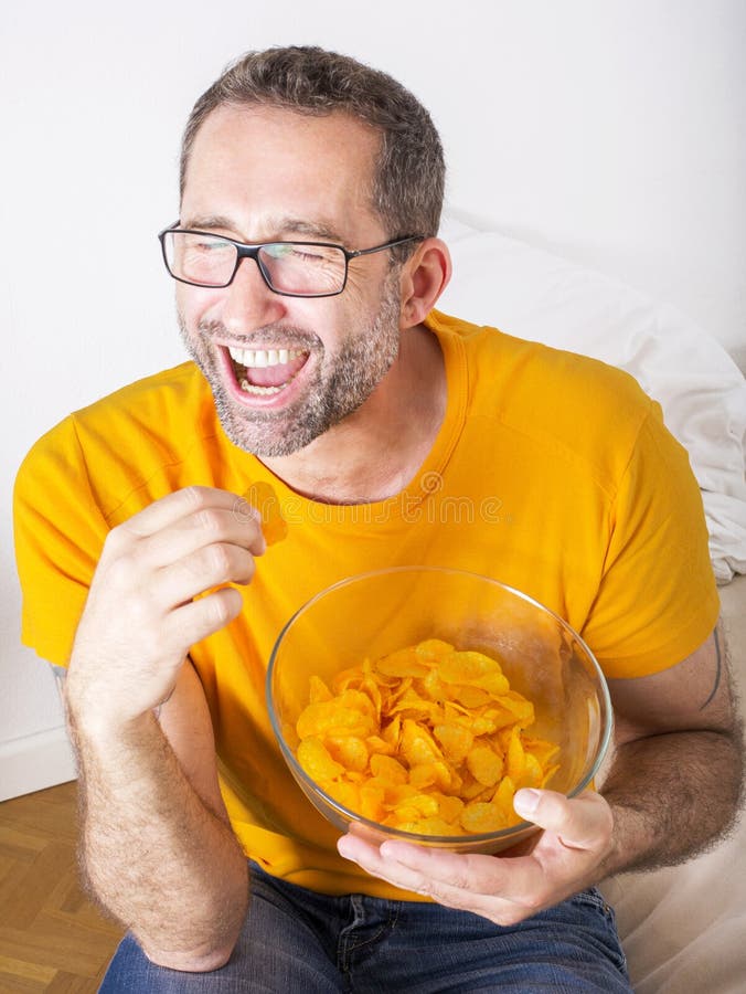 Man eating potato chips stock image. Image of food, attractive 42281189