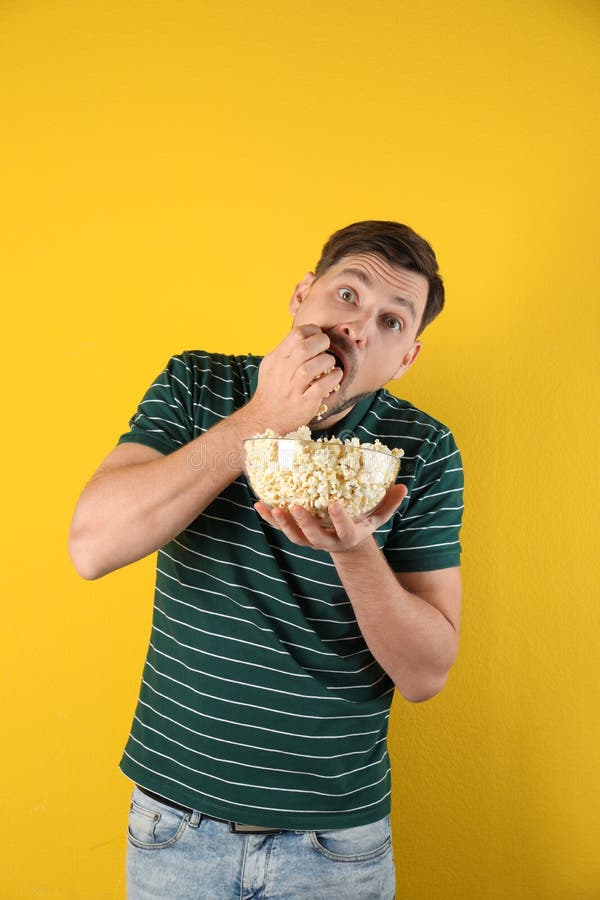 Man eating tasty popcorn stock image. Image of mature 140840827