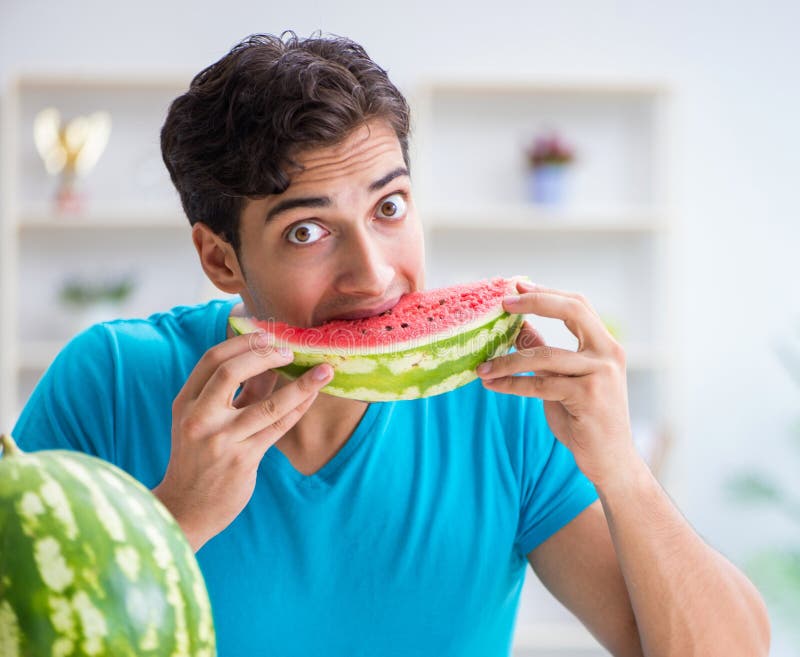Man Eating Watermelon at Home Stock Photo Image of healthy, handsome