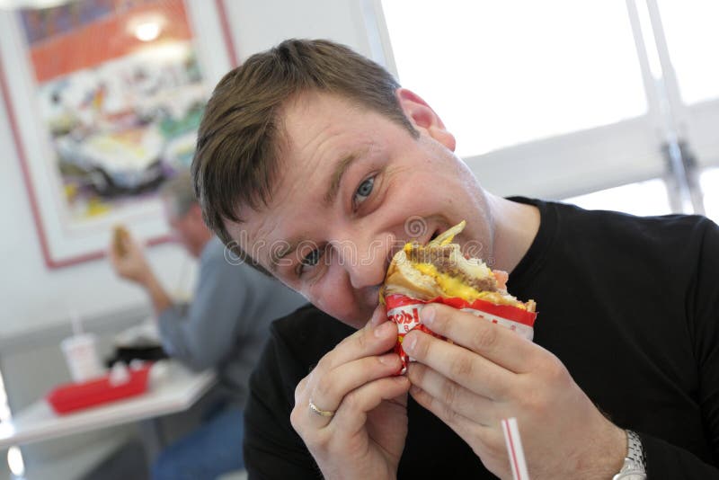 Man eats hamburger