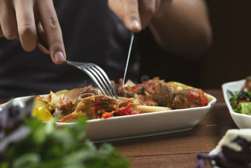Man Eats Lamb Stew on the Bone with Vegetables Stock Photo Image of