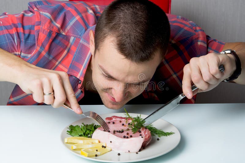 Man eats raw meats stock photo. Image of steak, hungry 85021914