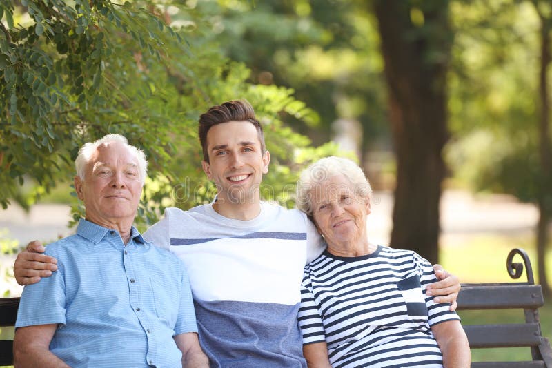 Man with elderly parents on bench